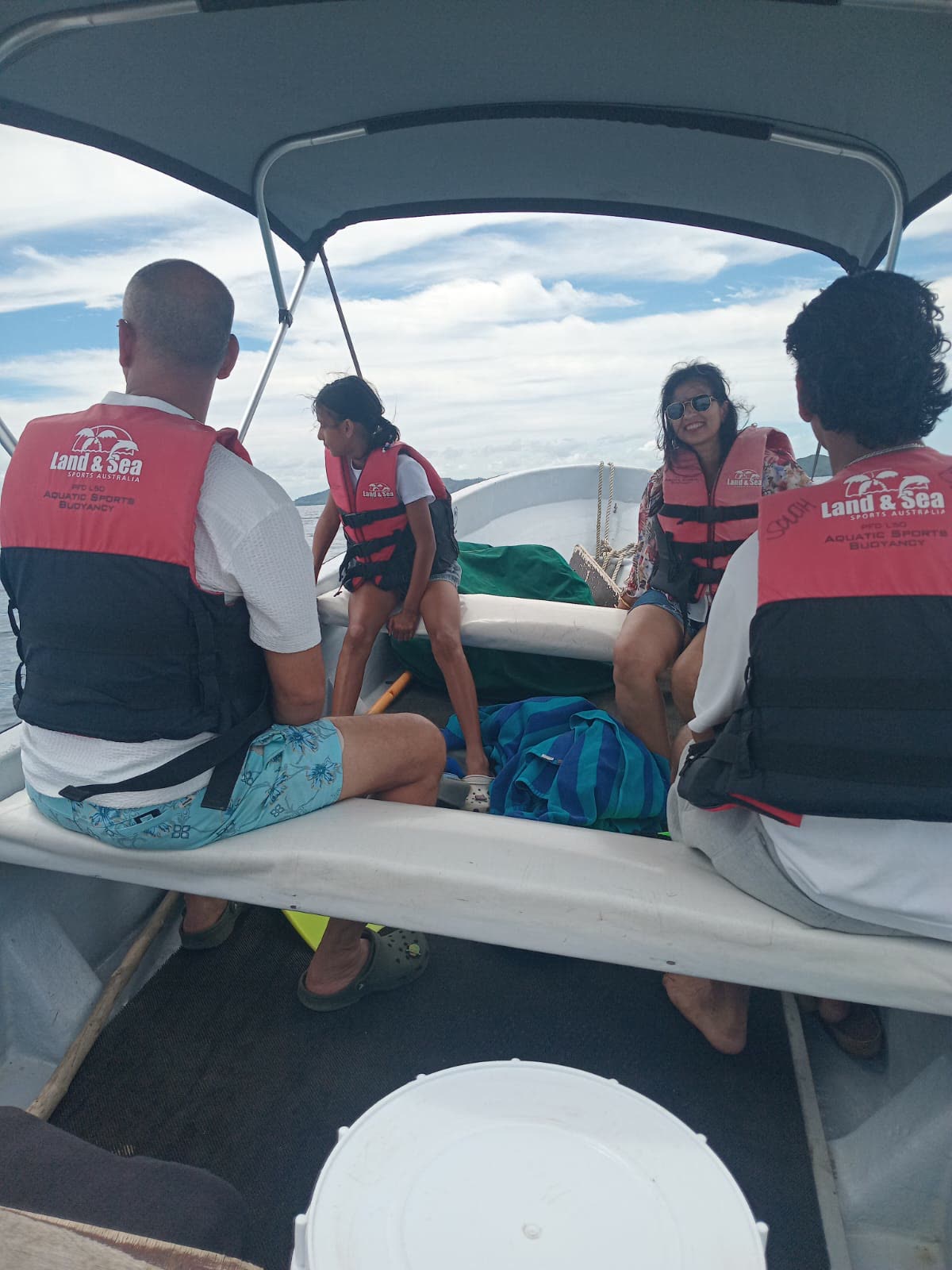 Guests wearing Land & Sea Sports Australia buoyancy life jackets on Joe's boat